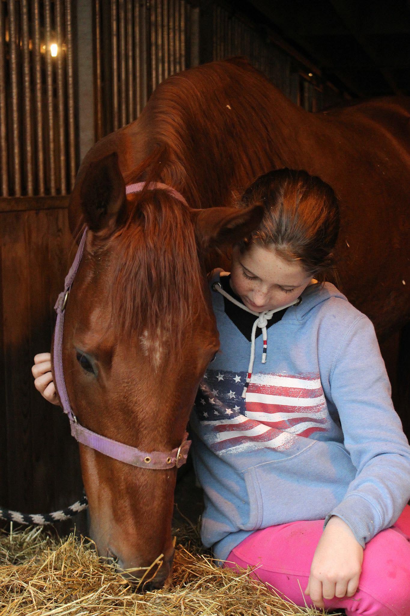 A young person spending quiet time with a rescued racehorse